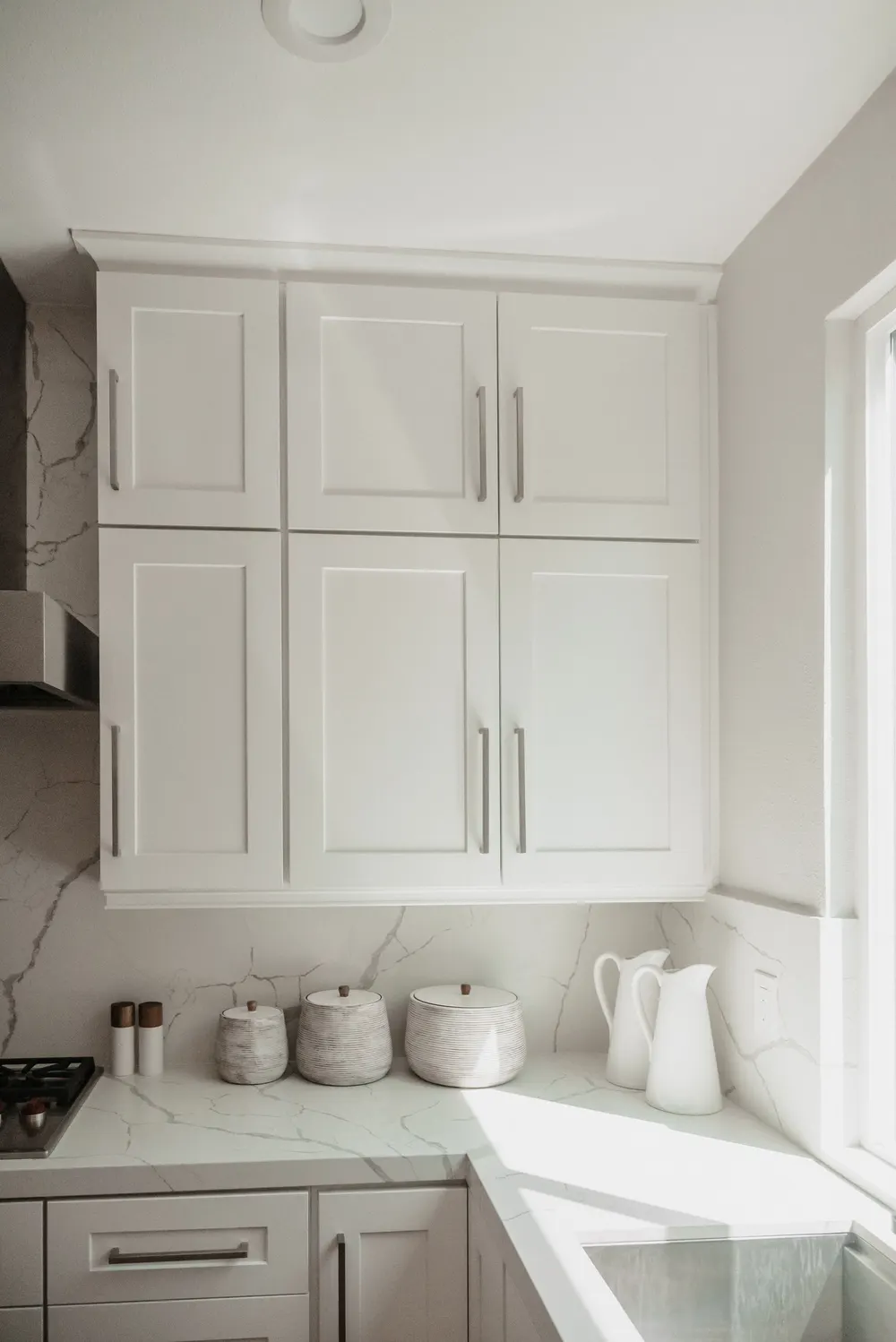 Bright white kitchen with marble countertops