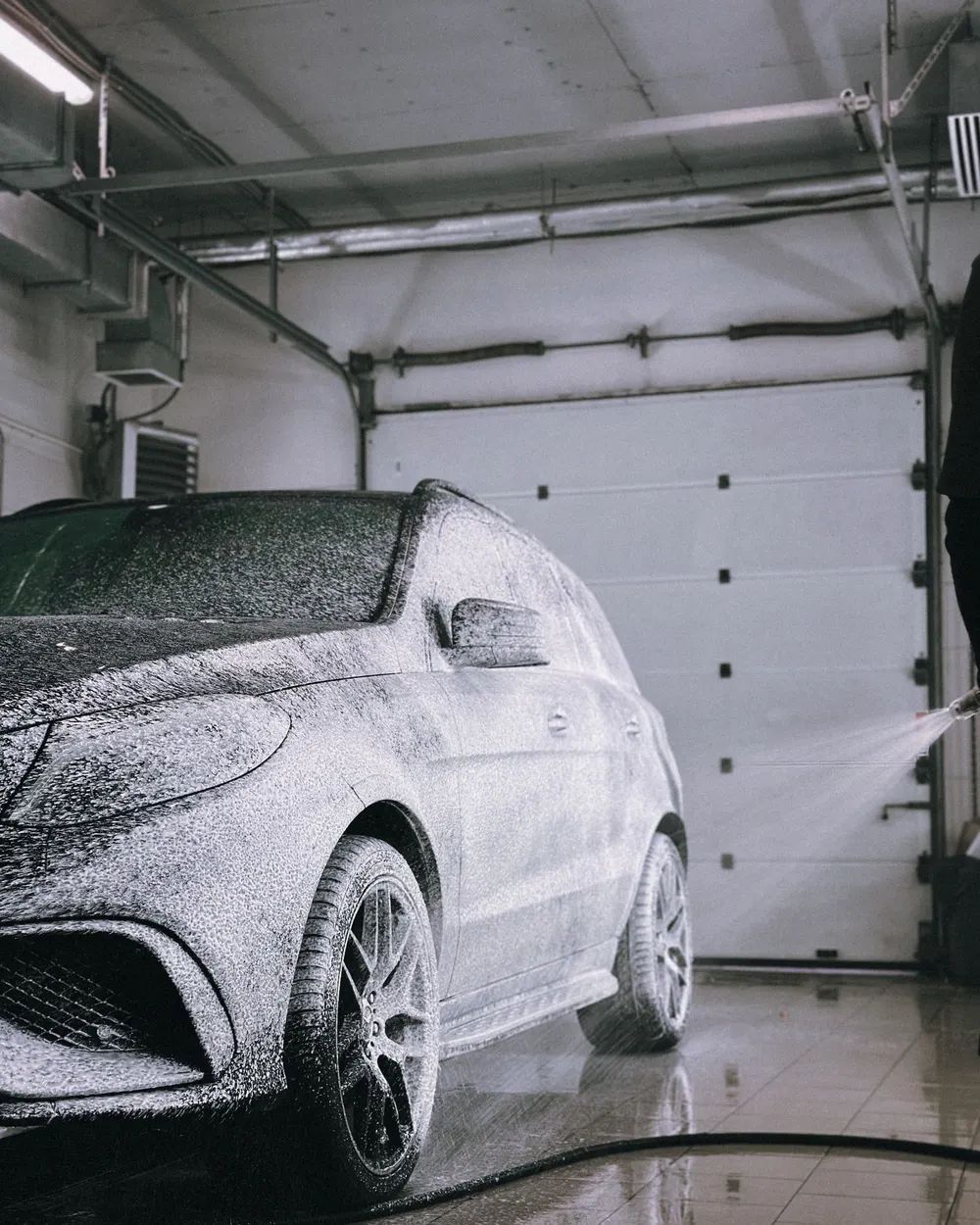 Car covered in snow foam during a pre-wash