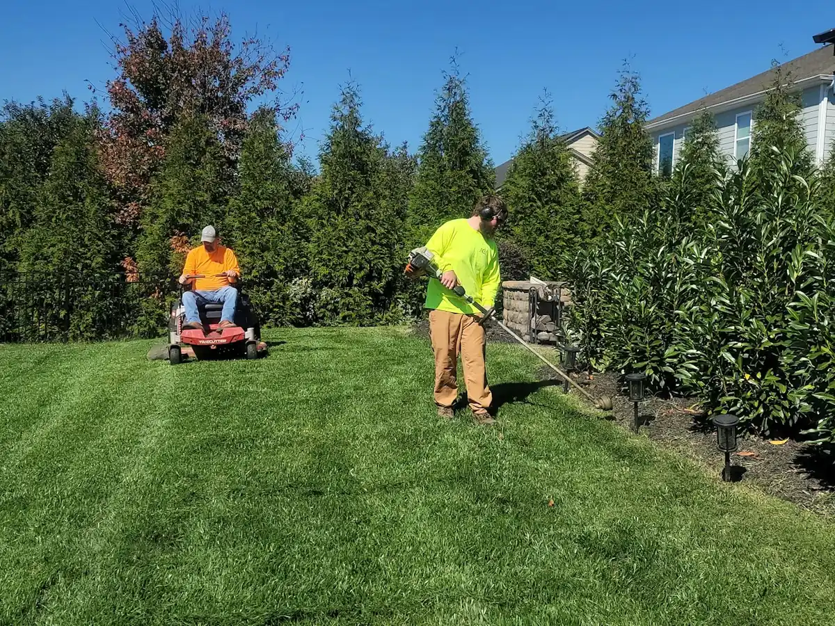 Lawn care crew mowing a residential lawn