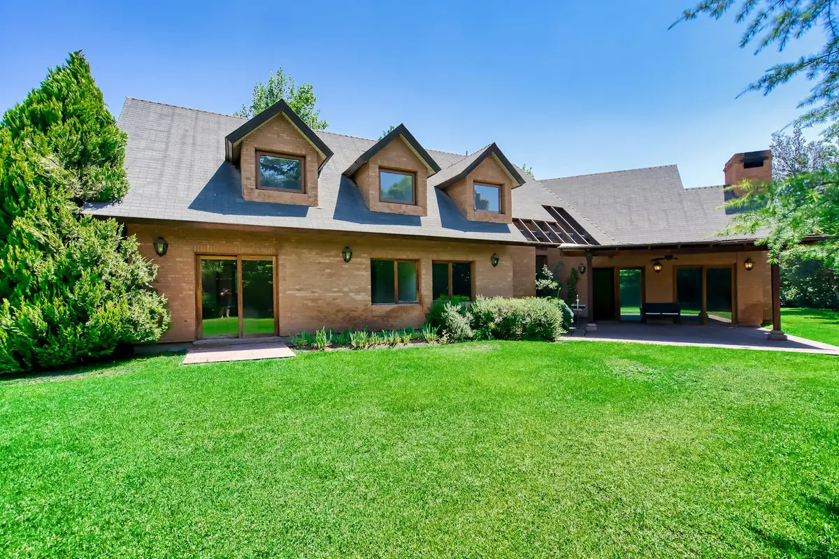 Two-story home with a wide, lush front lawn