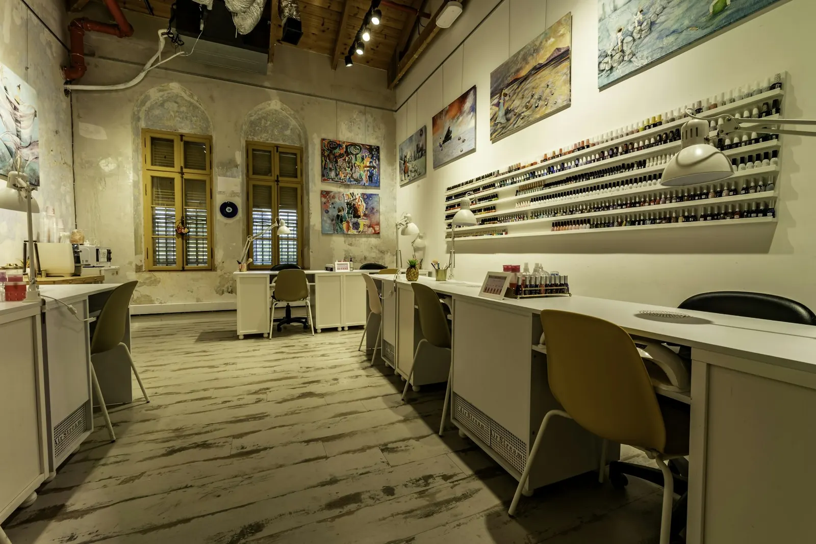Nail salon with manicure stations and a wall of polish colors