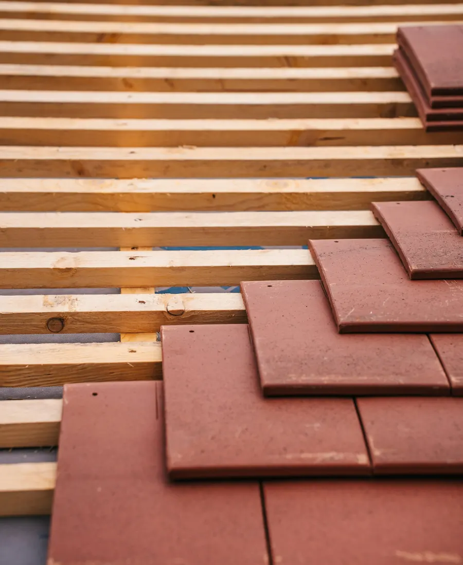 New roof tiles being laid over wooden battens