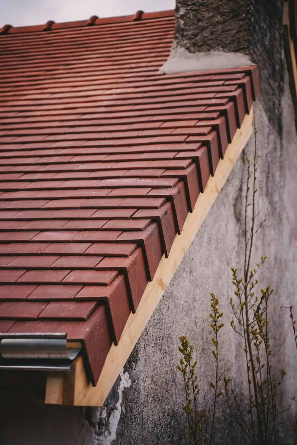 Newly tiled roof edge with a gutter