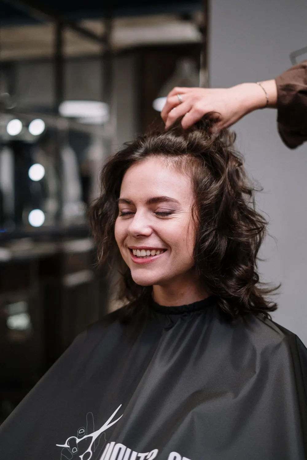 Smiling client with freshly styled curls
